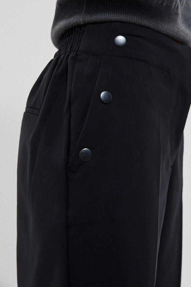 Pants with decorative buttons